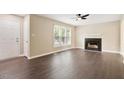 Inviting living room with wood flooring, fireplace, ceiling fan, and abundant natural light at 71 E Boxley Dr, Wendell, NC 27591