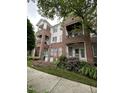Three-story brick condo building with balconies and beautiful landscaping near sidewalks and lawn at 710 N Person St # 103, Raleigh, NC 27604