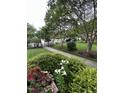 Well-maintained lawn and walking path with mature trees and landscaping in a peaceful neighborhood at 710 N Person St # 103, Raleigh, NC 27604