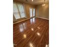 Bright living room featuring gleaming hardwood floors, neutral paint, chandelier, and French doors at 710 N Person St # 103, Raleigh, NC 27604