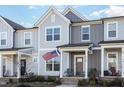 Attractive two-story townhome featuring a covered front porch and a neatly landscaped front yard at 728 Silo Park Dr, Wake Forest, NC 27587
