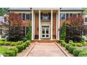 Front entry featuring a brick walkway, classic columns, and manicured greenery at 820 Kenmore Rd, Chapel Hill, NC 27514