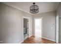 Hallway featuring hardwood floors and doorways leading to additional rooms and features at 913 Harrison Ridge Rd, Wake Forest, NC 27587