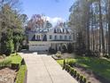 Charming two-story home with a spacious front yard, manicured landscaping, and a long driveway at 1006 Henny Pl, Raleigh, NC 27614