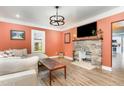 Inviting living room featuring a stone fireplace, hardwood floors, and an abundance of natural light at 109 St Marys St, Garner, NC 27529