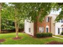 Beautiful end-unit townhome featuring manicured landscaping and lush green lawn at 10941 Pendragon Pl, Raleigh, NC 27614