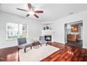 Bright living room with hardwood floors, fireplace, and open access to the kitchen at 10941 Pendragon Pl, Raleigh, NC 27614
