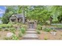 Beautifully landscaped front entrance with a brick walkway and decorative iron gate at 1164 Keith Hills Rd, Lillington, NC 27546