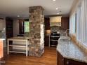 Spacious kitchen with granite countertops, modern appliances, and a center island at 119 W Vernon Ave, Wake Forest, NC 27587