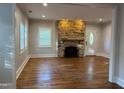 Bright living room featuring a stone fireplace and hardwood floors at 119 W Vernon Ave, Wake Forest, NC 27587