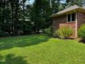 Side yard featuring a brick facade at 143 Cedarwood Dr, Henderson, NC 27536