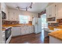 Bright kitchen with white cabinets, wood countertops, and wood backsplash at 1500 Prisma Ct, Raleigh, NC 27612