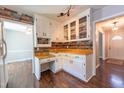 Cozy kitchen featuring white cabinets, wood countertops, and wood backsplash at 1500 Prisma Ct, Raleigh, NC 27612