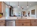 Bright kitchen with a central island, stainless steel dishwasher, granite countertops, and access to the living area at 157 Mildred Pl, Broadway, NC 27505
