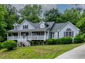Inviting two-story home featuring a spacious front porch perfect for relaxing at 180 Normandy Rd, Louisburg, NC 27549
