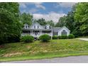 Beautifully landscaped home with a classic design and an inviting front porch at 180 Normandy Rd, Louisburg, NC 27549