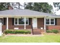 Inviting brick home with a covered front porch, perfect for relaxing outdoors at 205 N Augusta Ave, Benson, NC 27504