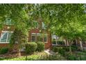 Charming brick townhome with mature landscaping and inviting curb appeal at 218 W Barbee Chapel Rd, Chapel Hill, NC 27517