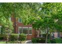 Charming brick townhome with mature landscaping and inviting curb appeal at 218 W Barbee Chapel Rd, Chapel Hill, NC 27517