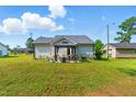 Expansive backyard featuring a gazebo with string lights for outdoor enjoyment at 221 Moon Cir, Dunn, NC 28334