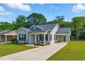 Attractive home featuring a lush lawn, inviting porch and convenient attached carport at 221 Moon Cir, Dunn, NC 28334