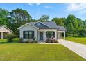 Attractive home featuring a lush lawn, inviting porch and convenient attached carport at 221 Moon Cir, Dunn, NC 28334