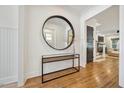 Elegant foyer featuring hardwood floors, a modern console table, and large mirror at 245 Tumbling River Dr, Wendell, NC 27591