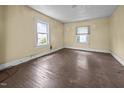 Bright bedroom with hardwood floors, two windows bringing in natural light, and neutral colored walls at 312 W Front St, Oxford, NC 27565
