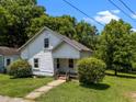 Quaint two-story home with an inviting front yard and well-established greenery creating a serene setting at 312 W Front St, Oxford, NC 27565