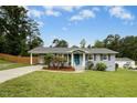 A beautifully landscaped home with a well-maintained lawn and a side carport at 4021 Chaucer Dr, Durham, NC 27705