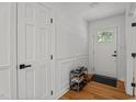 Bright entryway with hardwood floors, white trim and door with glass paneling at 4259 Old Faison Rd, Knightdale, NC 27545