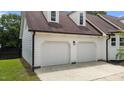 Spacious two-car garage with white doors, brown roof and side door at 4259 Old Faison Rd, Knightdale, NC 27545