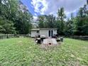 This backyard setting has a wooden deck, complete with outdoor cooking essentials at 4601 Orange Grove Rd, Hillsborough, NC 27278