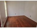 This bedroom features hardwood floors, and neutral colored walls at 5301 Peacenest Dr, Raleigh, NC 27610