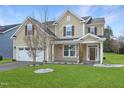 Charming two-story home with a well-manicured lawn and a two-car garage at 800 Tree Green Ln, Wake Forest, NC 27587