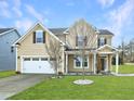 Charming two-story home with a well-manicured lawn and a two-car garage at 800 Tree Green Ln, Wake Forest, NC 27587
