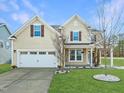 Charming two-story home with a well-manicured lawn and a two-car garage at 800 Tree Green Ln, Wake Forest, NC 27587