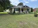 Charming yellow home with a welcoming front porch and beautifully landscaped front yard at 9439 Clayton Blvd, Clayton, NC 27520