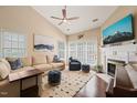 Comfortable living room with a fireplace, ceiling fan, and plenty of natural light at 1 Lake Hill Dr, Durham, NC 27713