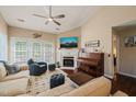 Bright living room with a cozy fireplace, piano, and comfortable seating at 1 Lake Hill Dr, Durham, NC 27713