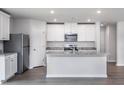 Modern kitchen with granite countertops, stainless steel appliances, and bright white cabinetry at 10725 Farmall Dr, Middlesex, NC 27557