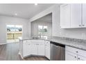 Bright kitchen with stainless steel appliances, granite countertops, and white cabinetry at 11640 International Dr, Middlesex, NC 27557