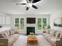 Bright living room with fireplace, ceiling fan, and large windows with lovely backyard views at 120 Point Harbor Dr, Cary, NC 27519