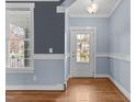 Dining space with outside access and hardwood floors, complemented by wainscotting and fresh paint at 130 Virginia Water Dr, Rolesville, NC 27571