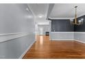 Open-concept living space with hardwood floors, decorative crown molding, and fresh paint throughout the home at 130 Virginia Water Dr, Rolesville, NC 27571