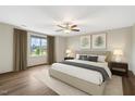 A bright, spacious bedroom featuring hardwood floors, a ceiling fan, and tranquil decor at 131 Hawick Ct, Zebulon, NC 27597