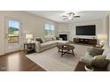 Inviting living room features a fireplace, stylish furnishings, and access to a backyard patio at 131 Hawick Ct, Zebulon, NC 27597
