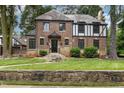 Handsome brick home with stone accents, mature trees, and a meticulously landscaped front yard at 1541 Caswell St, Raleigh, NC 27608