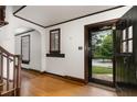 Bright foyer featuring hardwood floors, white walls, dark trim, and views of the front yard at 1541 Caswell St, Raleigh, NC 27608