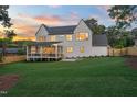 Expansive backyard featuring a covered patio, a lush lawn, and ample space for outdoor enjoyment at 217 Dublin Rd, Raleigh, NC 27609